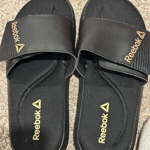 Reebok Black Slides with Metallic Gold Accent